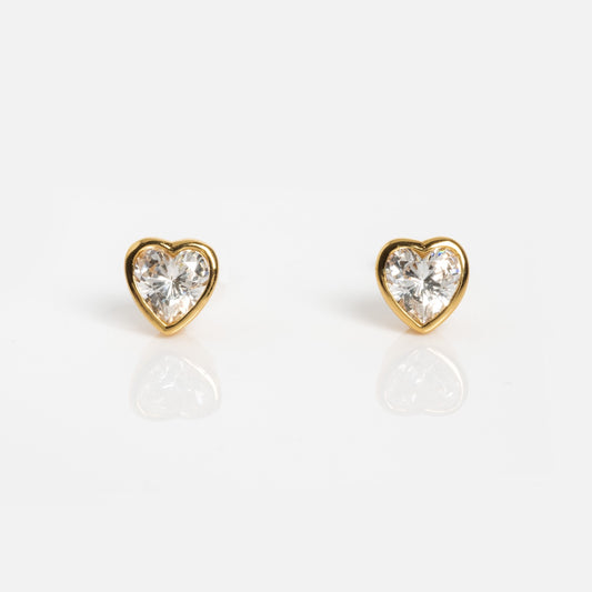 The Be My Baby Earrings are heart-shaped studs with simulated diamonds set in 18k yellow gold plated recycled brass, shown on a white background.