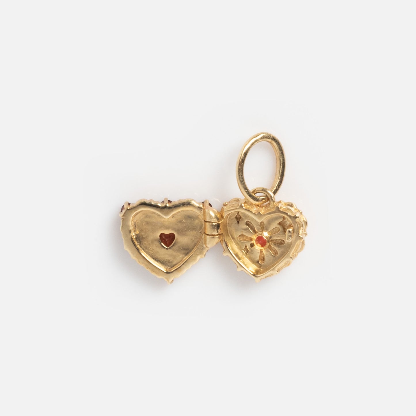 The Solid Gold Vintage Inspired Heart Cake Sample features a heart-shaped locket with a hinged opening, showcasing a red heart on one side and a floral motif with a red gem on the other, all set against a white background.