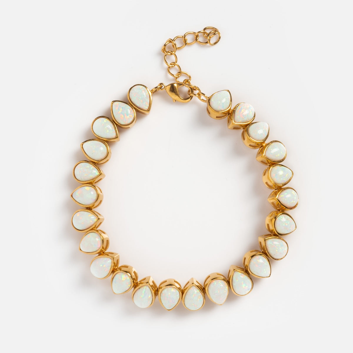 A gold chain necklace with teardrop-shaped opals pairs beautifully with our Bezel Set Birthstone Tennis Bracelet for an elegant look.