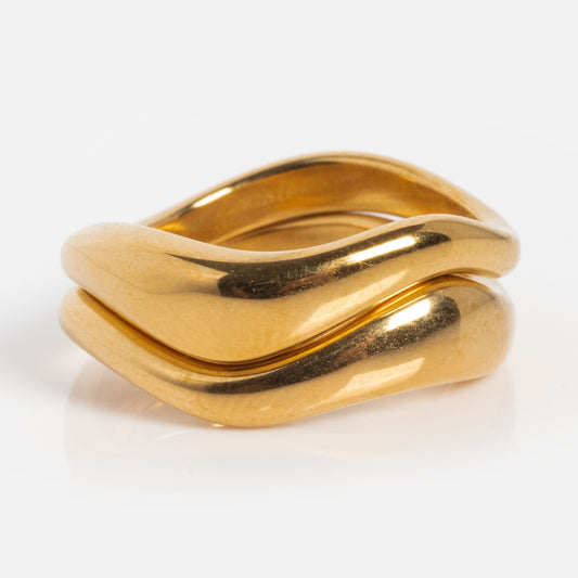 The Curves Ring Set features two curved, interlocking bands with a smooth, polished finish—ideal for stacking—displayed on a plain white background.