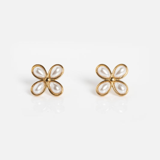Fleur Earrings: Gold earrings shaped like four-petal flowers, each petal made from a teardrop-shaped faux pearl, shown on a white background.