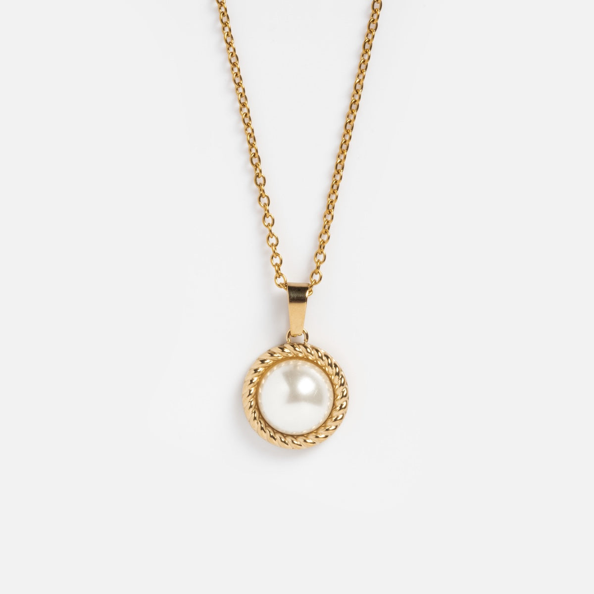 The Paloma Necklace features a yellow gold-plated round pendant with a single freshwater pearl, encircled by a twisted gold rope design, shown on a plain white background.