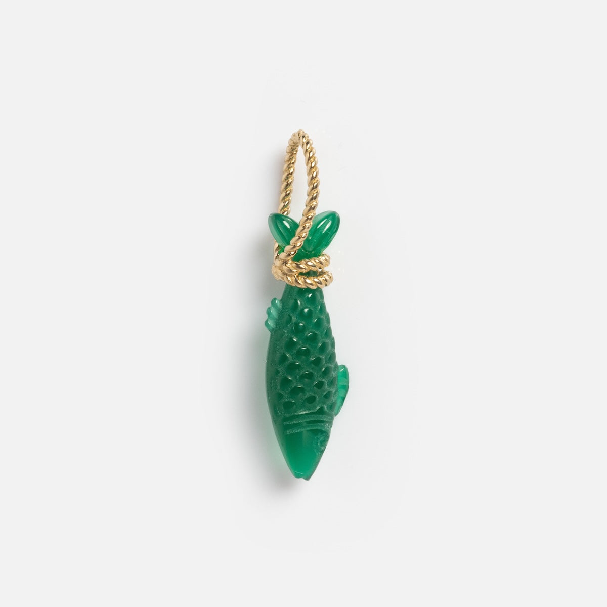 The Solid Gold Under The Sea Charm is a green fish-shaped pendant with textured details and a twisted gold loop for hanging, glowing against a plain white background.