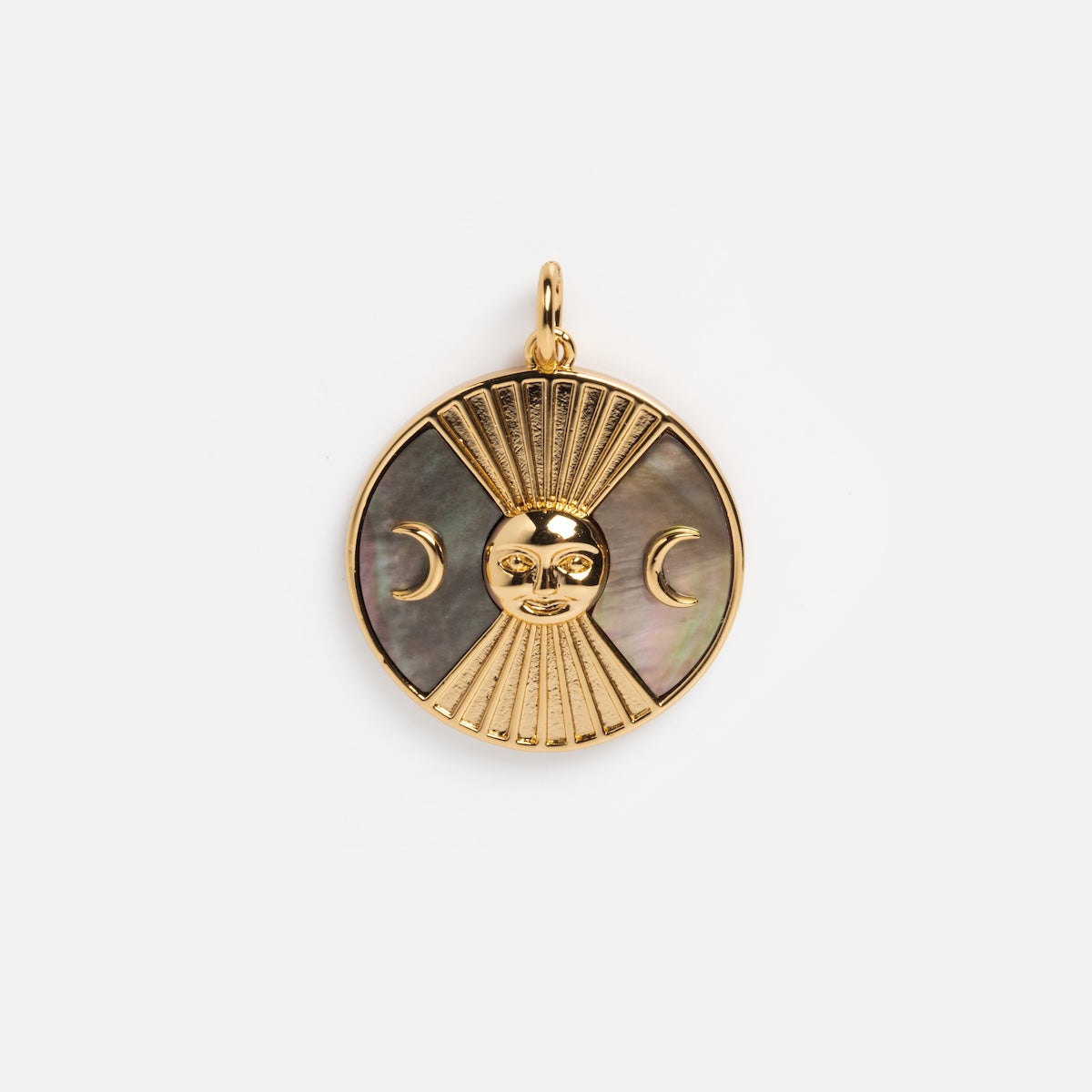 The Charms by Elizabeth Stone pendant is a round 14k gold plated celestial charm with a sun face, downward rays, crescent moons on each side, and a dark mother of pearl inlay. It has a loop at the top for easy attachment to any chain.