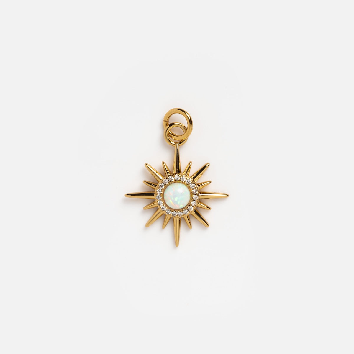 The Charms by Elizabeth Stone pendant features a 14k gold plated sunburst design with a central mother of pearl stone and sparkling clear crystals, capturing celestial elegance against a white backdrop.