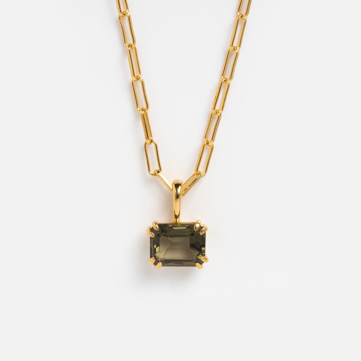 The Born to Shine Birthstone Necklace is a gold paperclip chain with a rectangular dark green gemstone pendant in a prong setting, shown against a plain white background.
