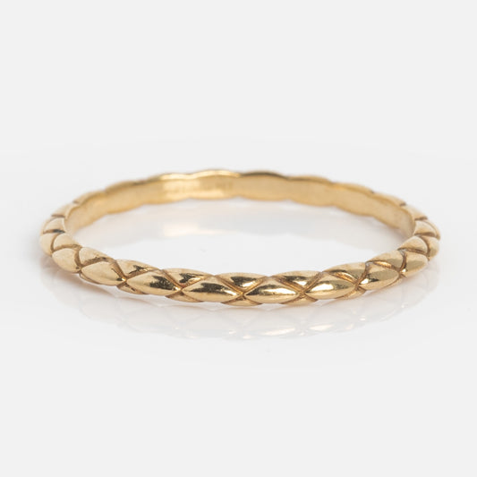 The Solid Gold Delicate Woven Stacking Ring features a thin yellow gold band with a textured, diamond-cut pattern, making it perfect for stacking and shown on a white background.