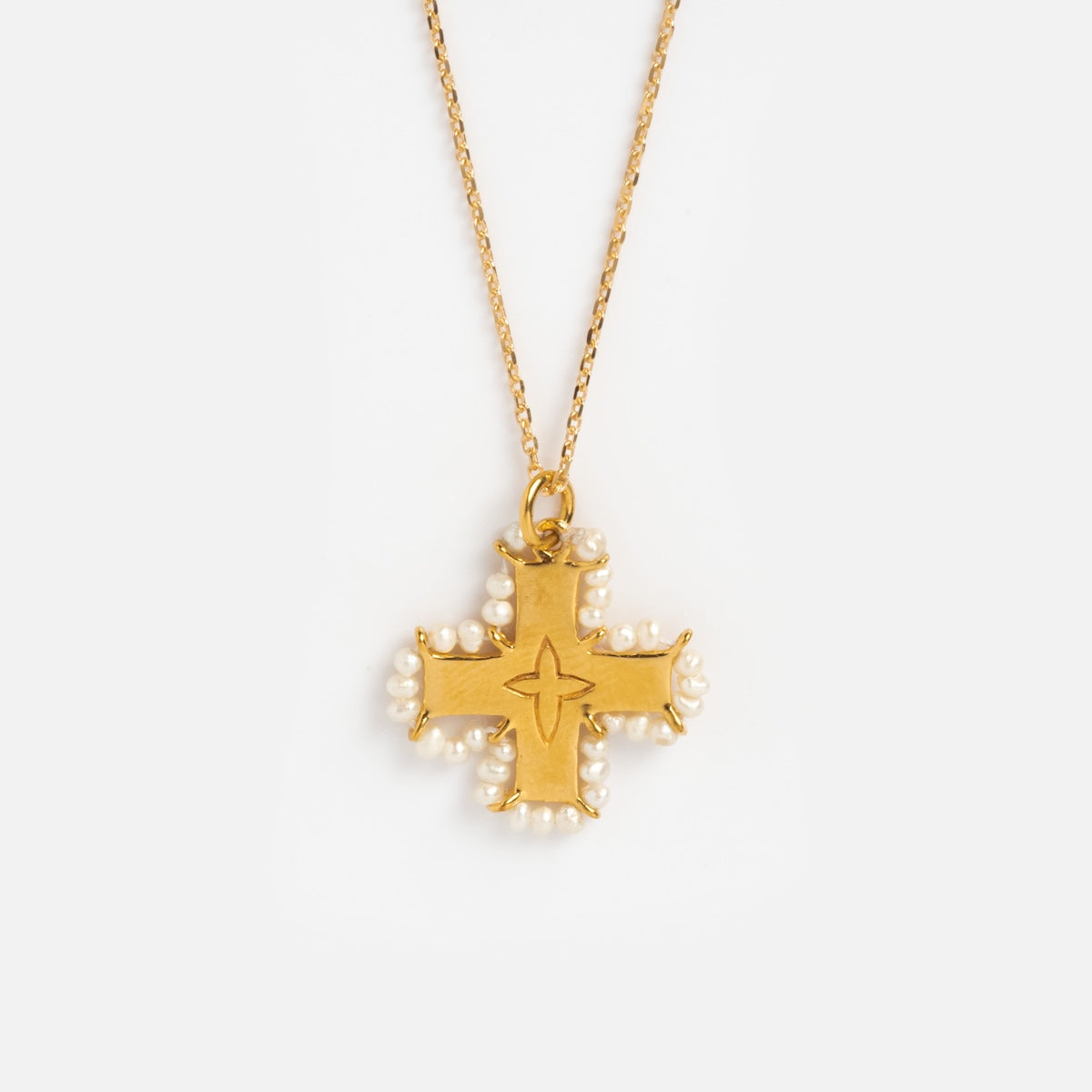 Close up of cross pendant with pearls