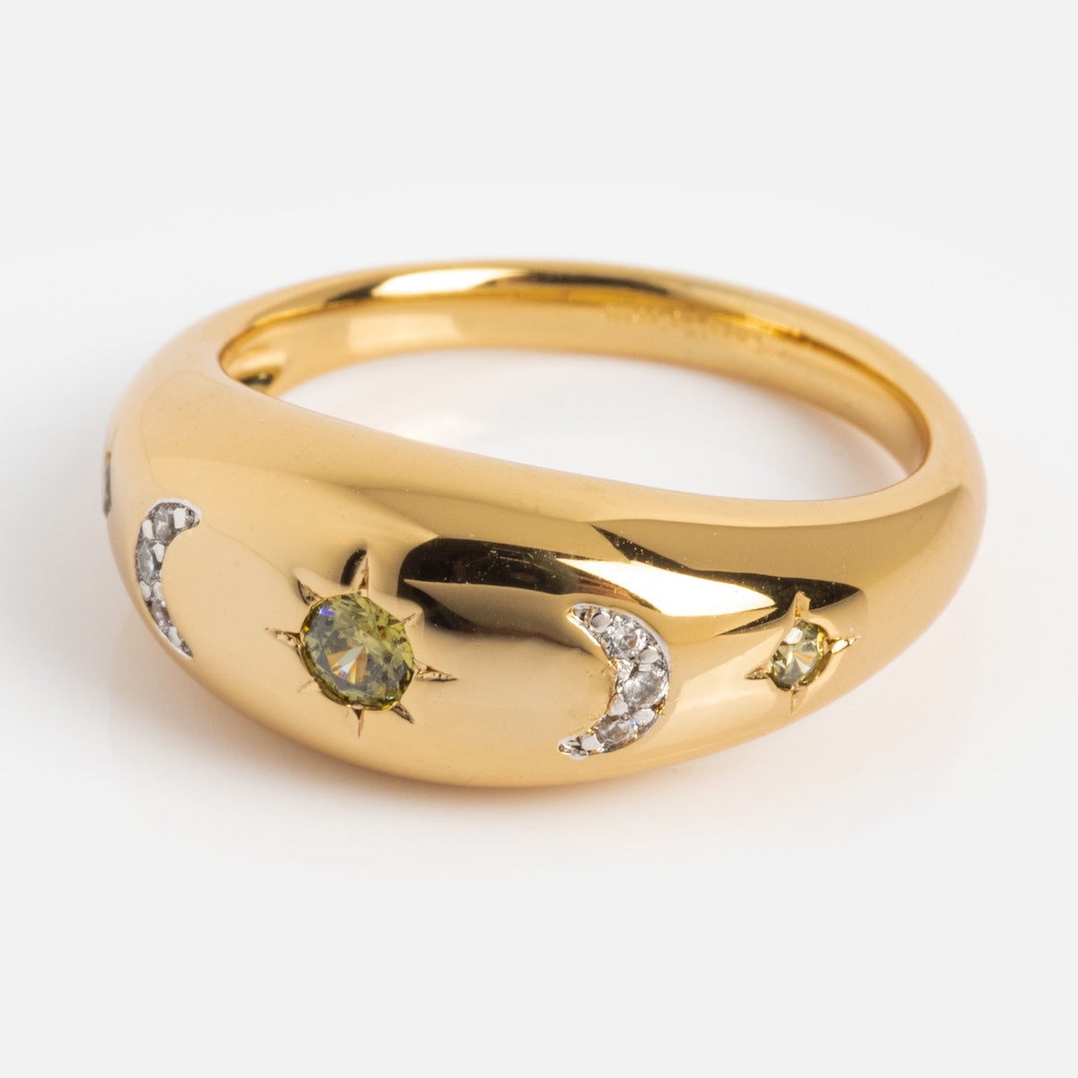 The Moonstruck Bold Dome Ring features a domed band with a sun motif, yellow gemstone, two diamond-inlaid crescent moons, and a star with green gemstone accents—all in 14k gold plate.
