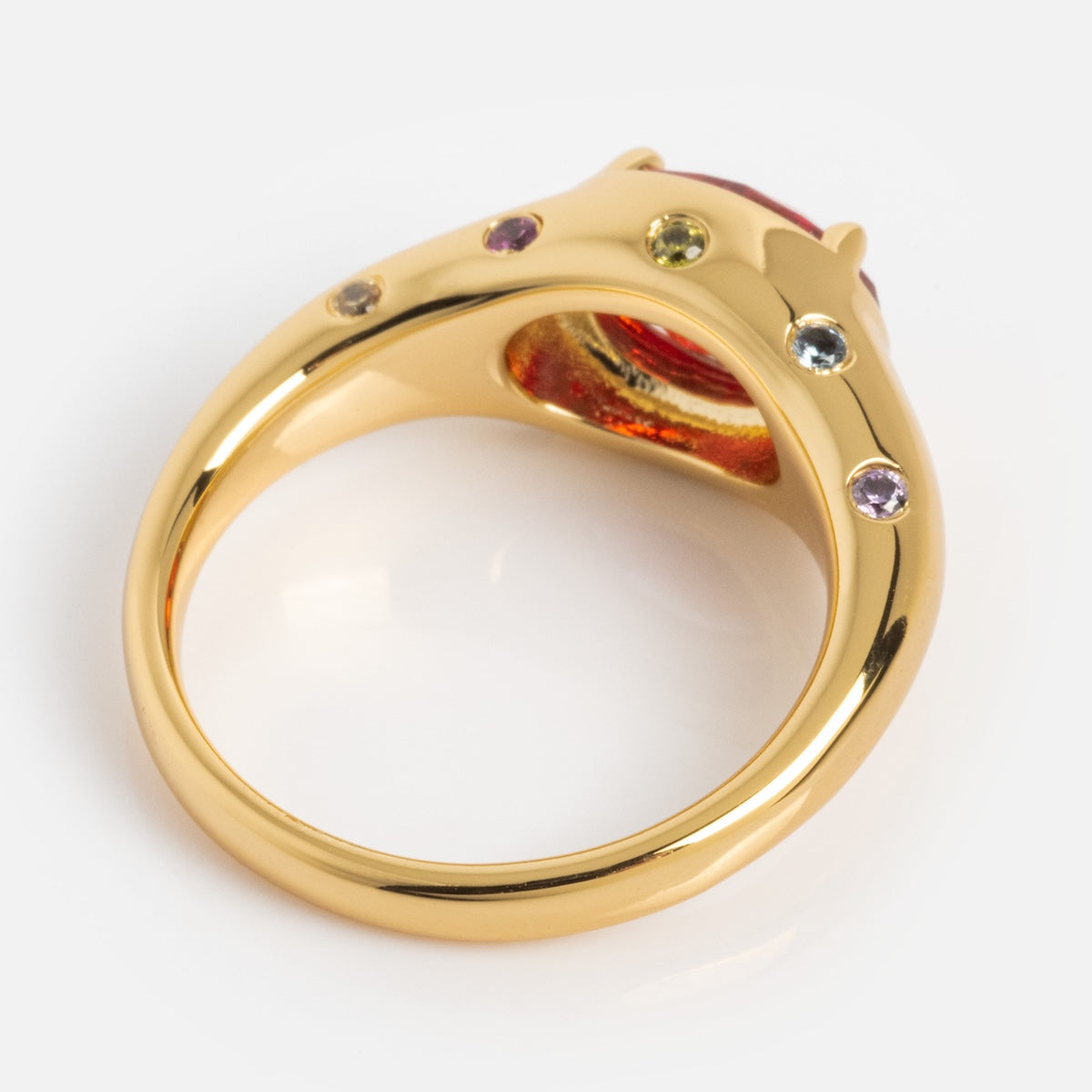 Gold ring with gemstones on a white background
