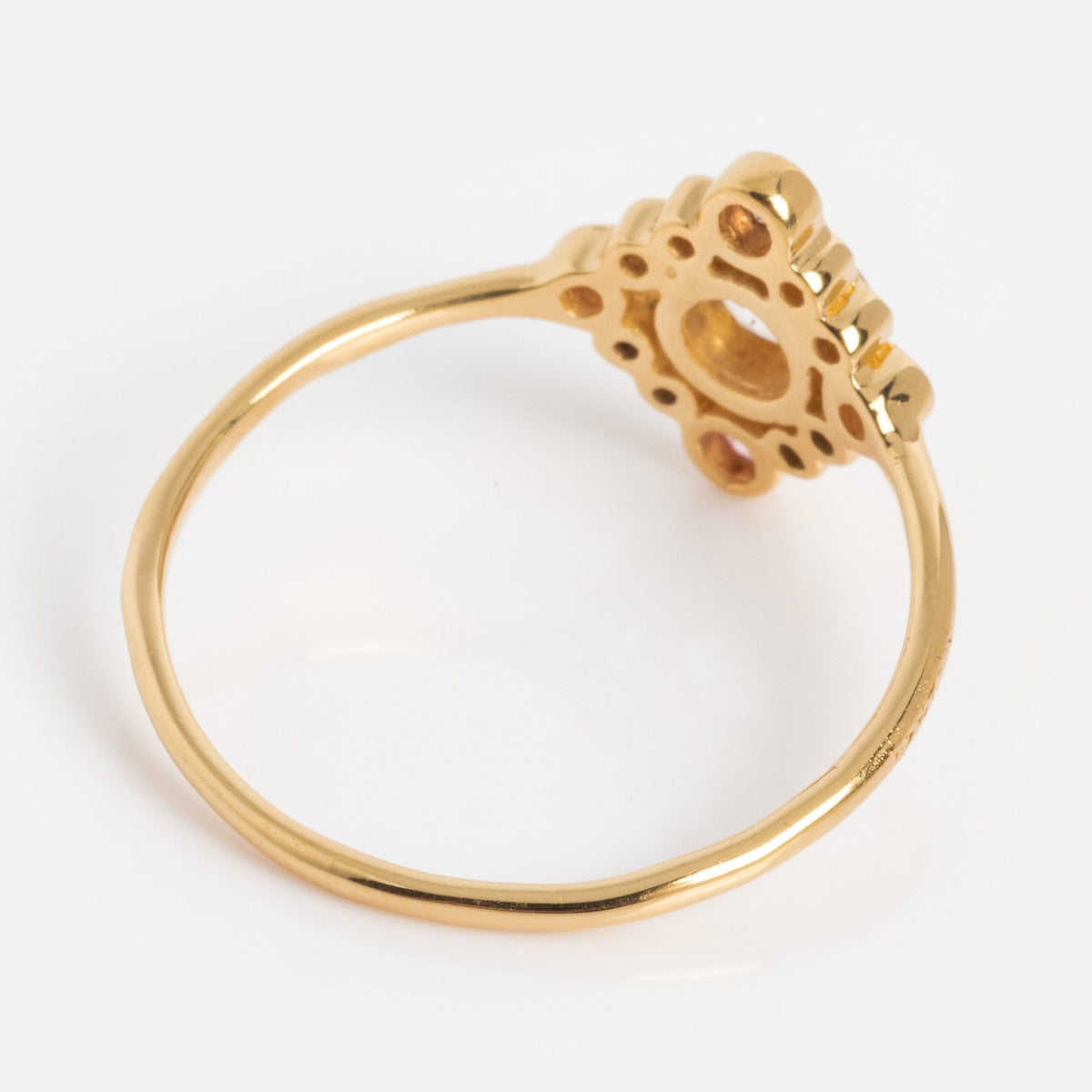 The Oberoi Ring features a thin yellow gold-plated band with an ornate openwork design on top, shown from a side angle against a white background.