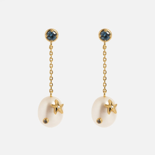The Gem Accent Pearl Drop Earrings feature 14k gold plating, blue gem-accented posts, delicate gold chains, oval white pearls, and small gold starfish accents on each pearl.