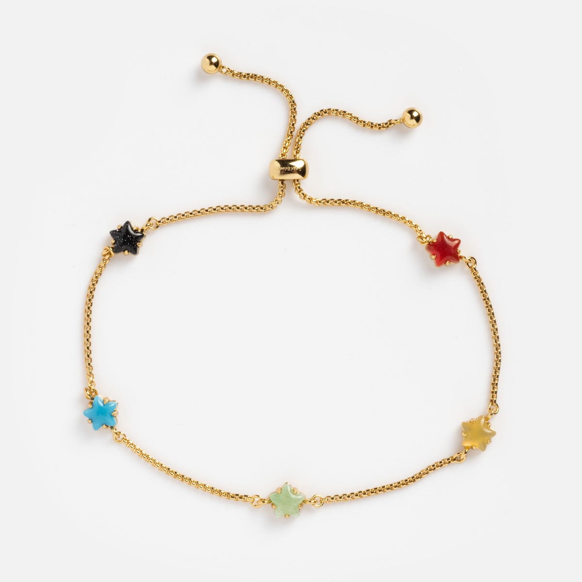 The Star Bright Bracelet is a delicate gold chain with an adjustable clasp and five star-shaped charms in black, red, blue, light green, and yellow.