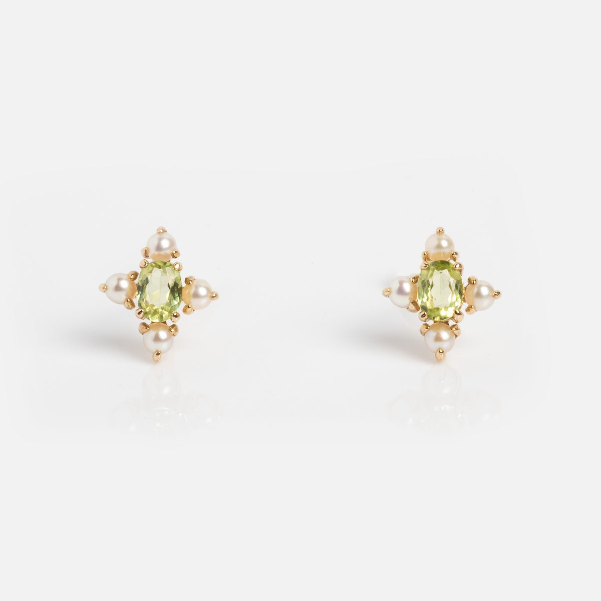 Peridot and pearl earrings on white