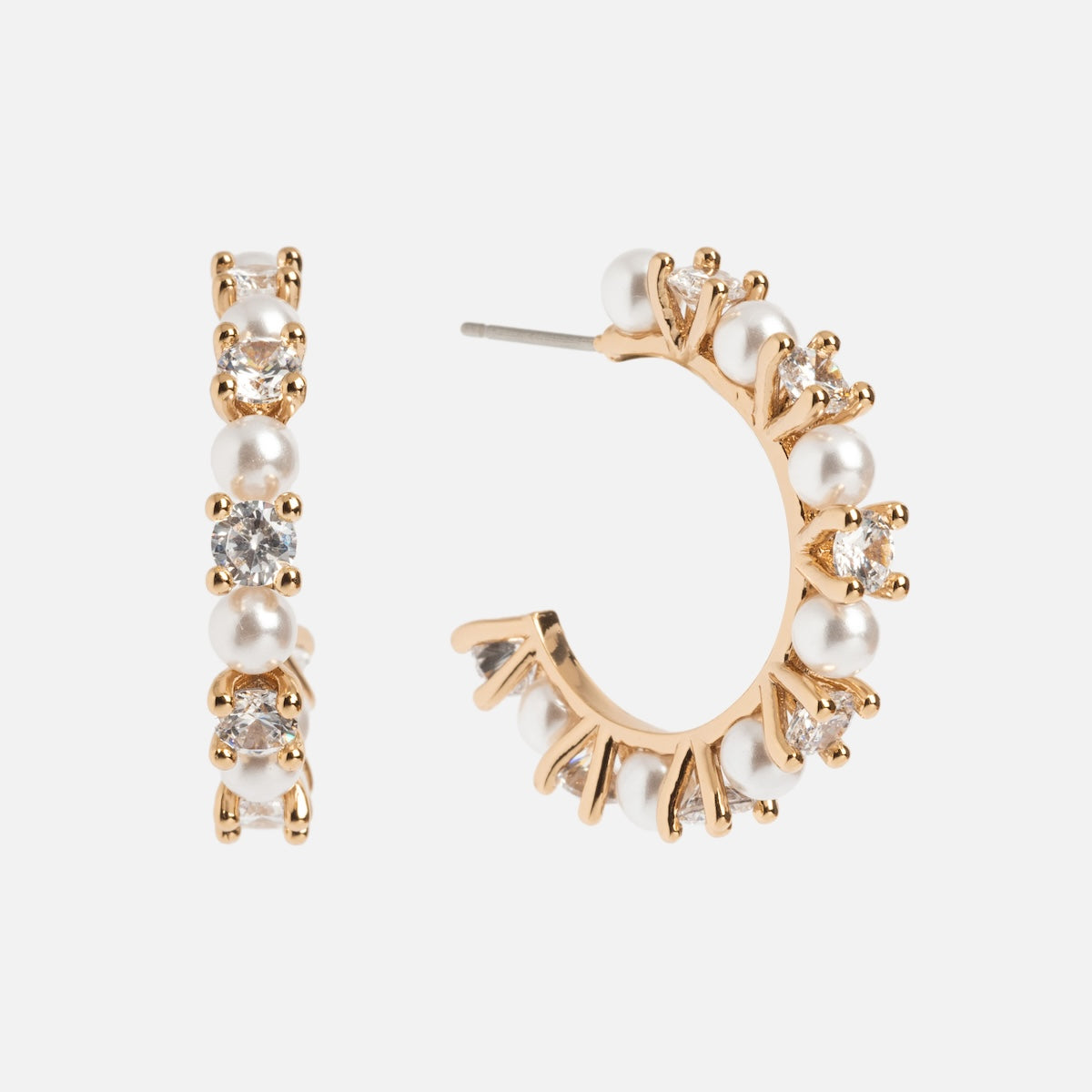 The Prive Hoops are gold plated earrings featuring alternating white pearls and clear gemstones. Displayed on a white background, one earring is shown from the front, the other from the side.