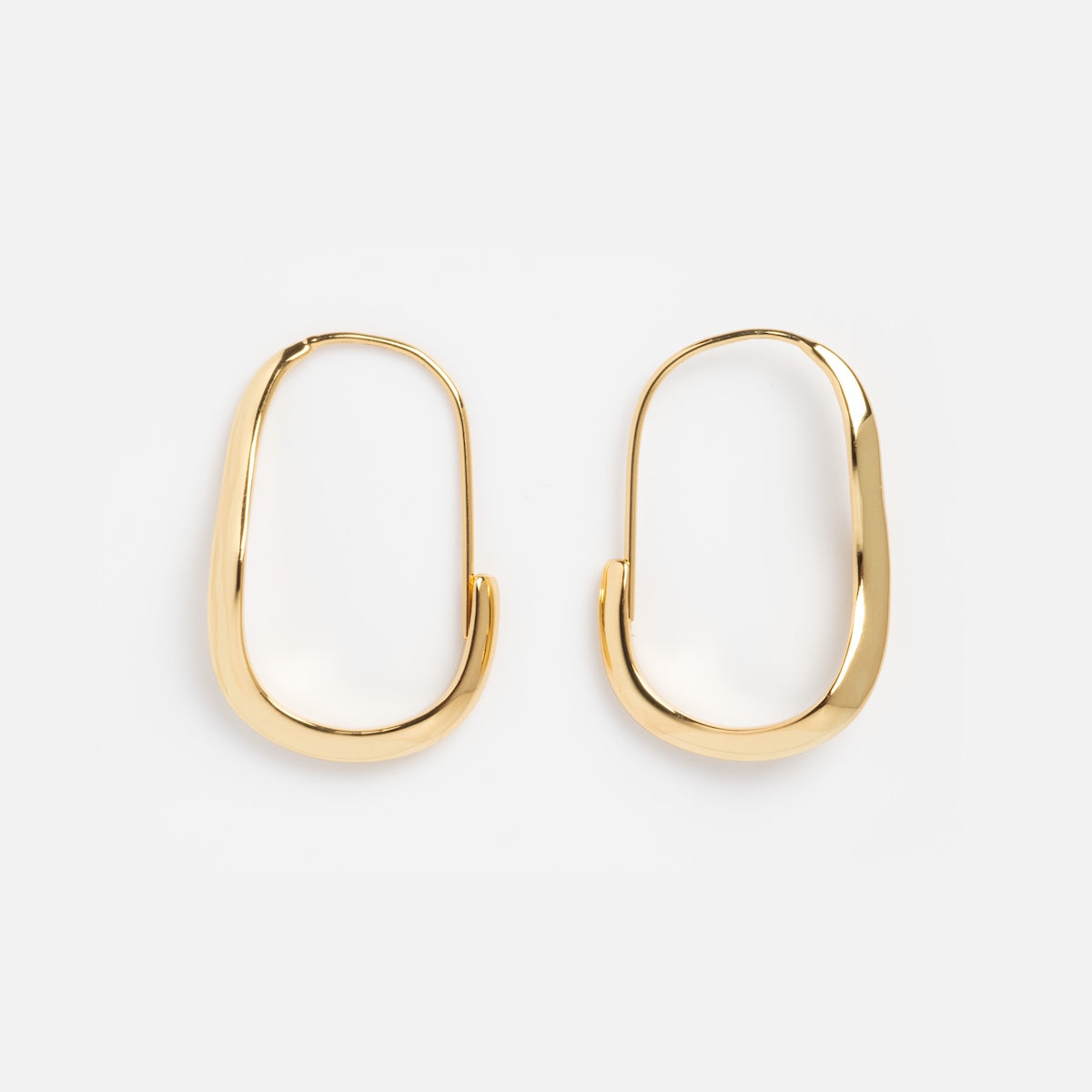The Mia Wave Hoops, crafted in 14k gold vermeil with a sleek oval silhouette, are modern gold hoop earrings shown on a plain white background.