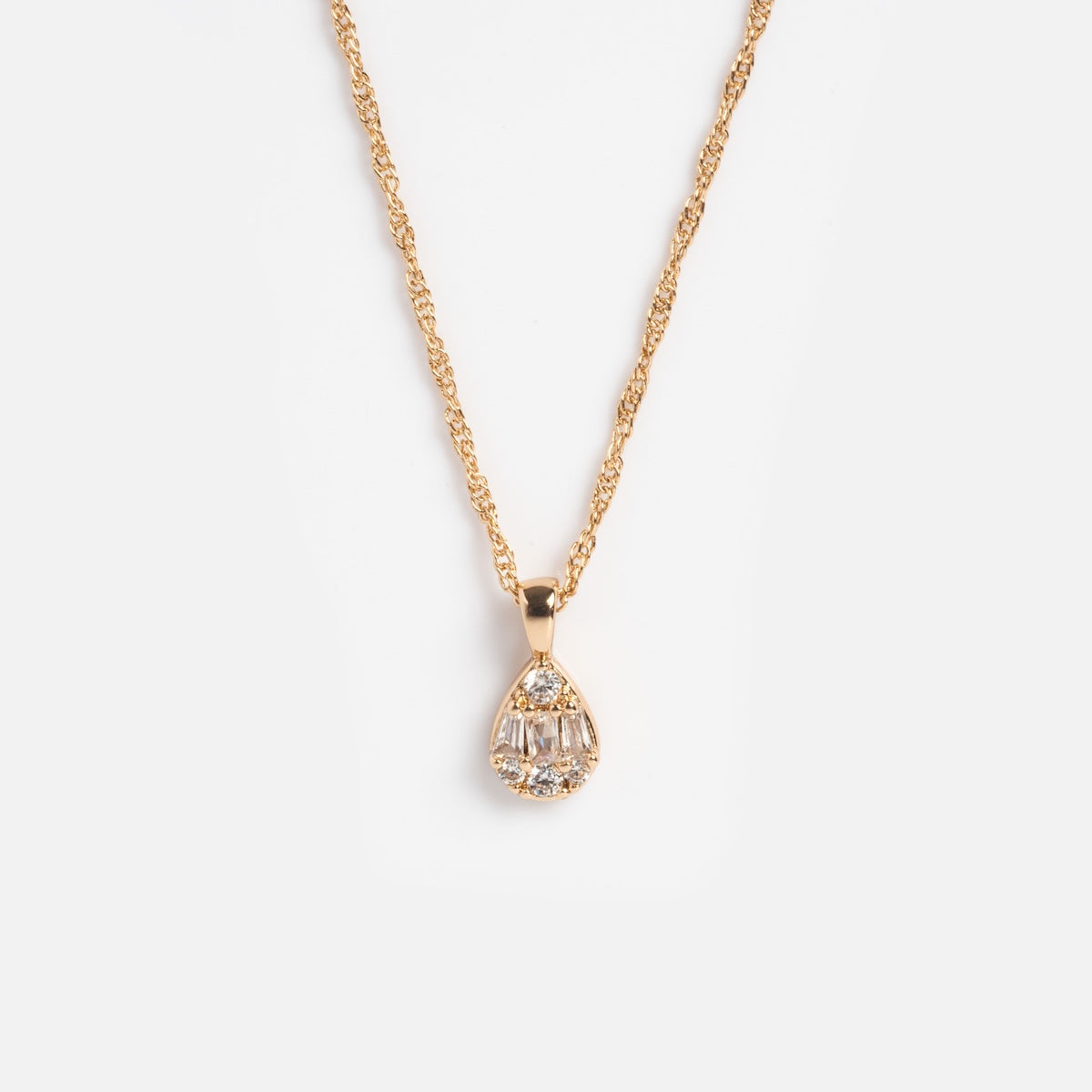 The Muzi Pendant Necklace features a teardrop pendant with clear gemstones on a 14k gold plated twisted rope chain, shown against a plain white background.