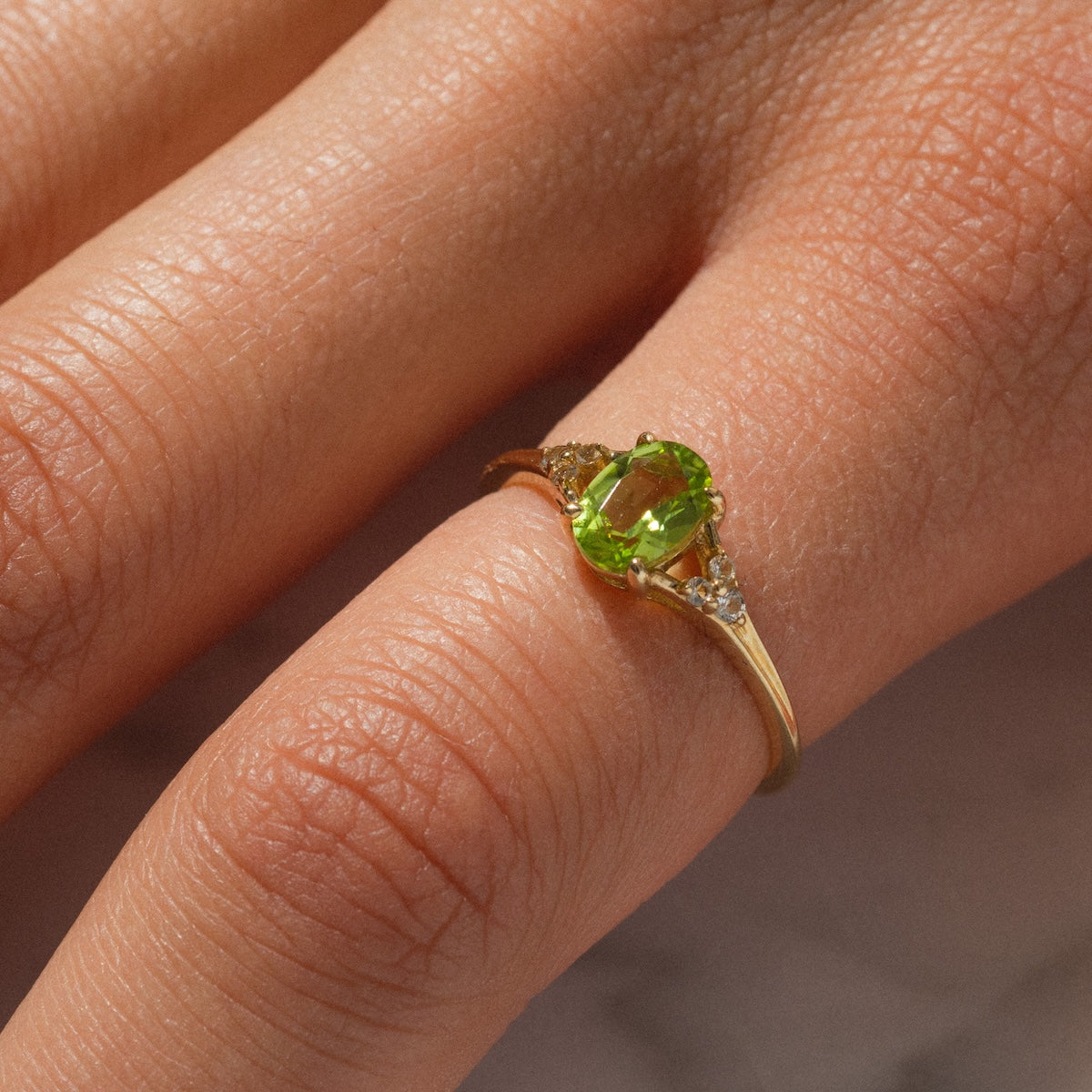 Close up of statement peridot ring on finger