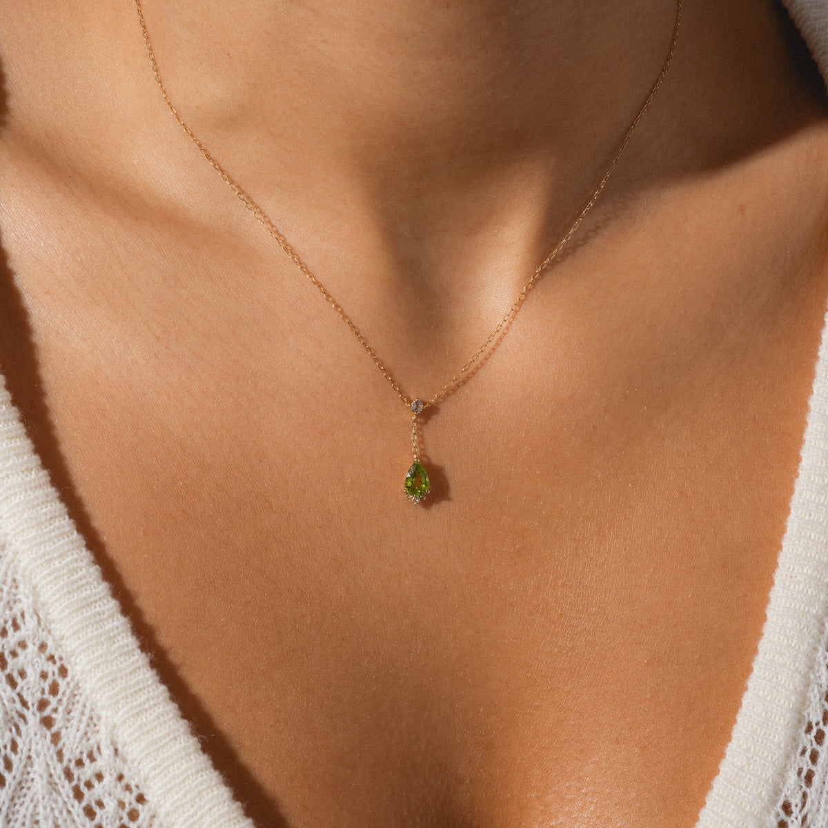Close up of peridot necklace being worn
