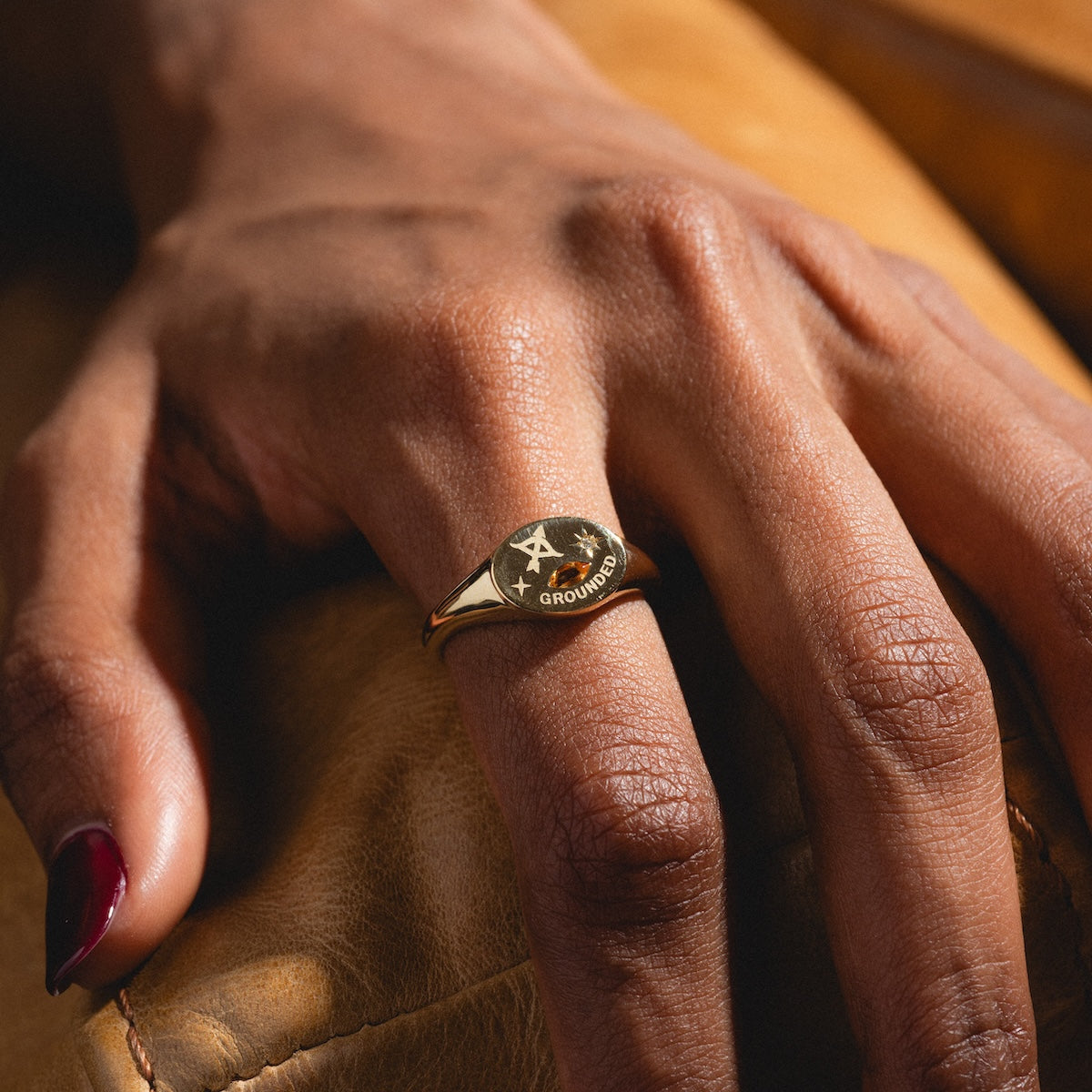 Hand wearing a gold manifestation ring