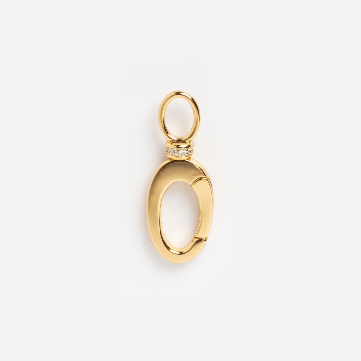 Exclusive to Local Eclectic, the Charm Clip features 14k gold vermeil, an oval shape with a hinged opening, a round top loop, and a row of sparkling stones set against a plain white background.