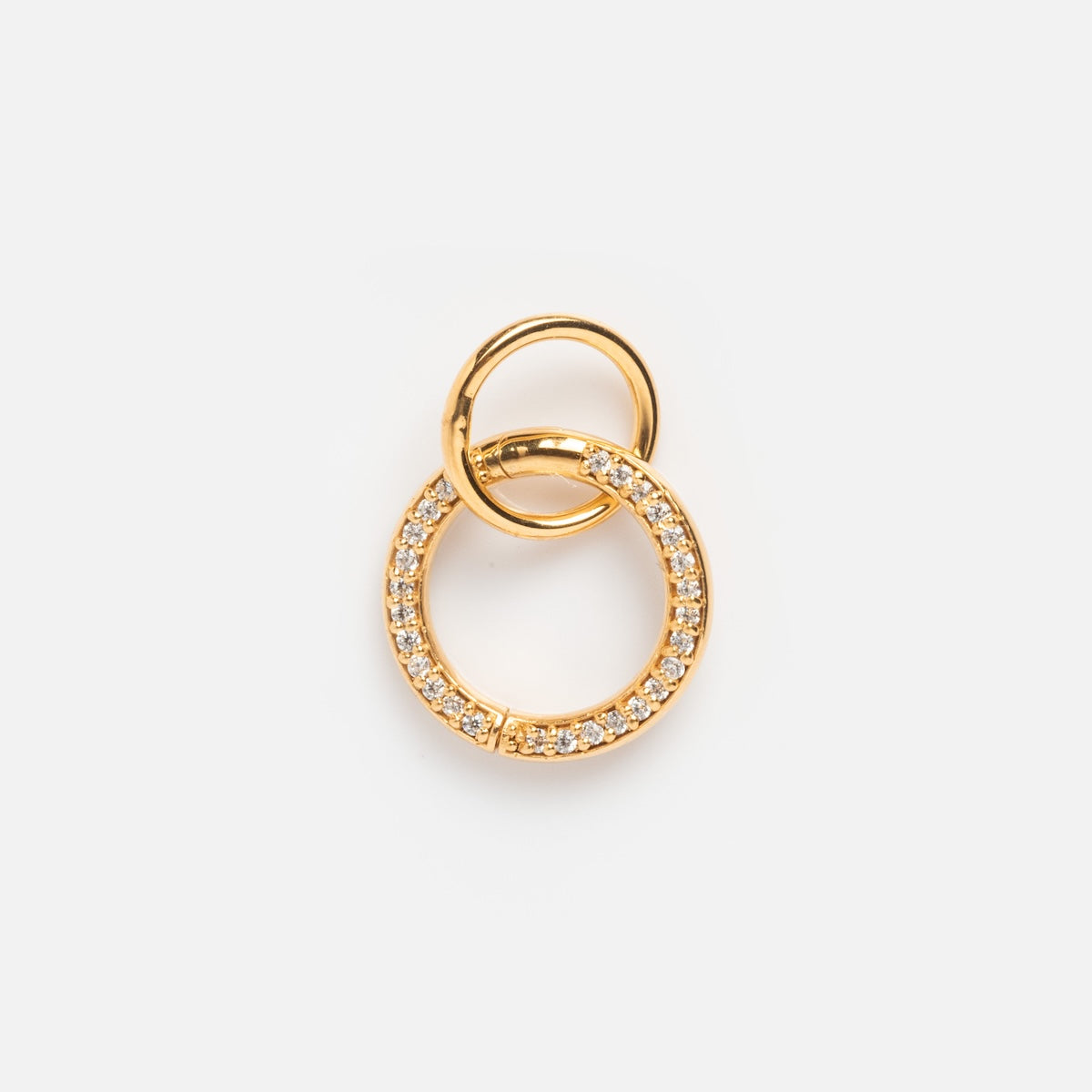 Exclusive to Local Eclectic, the Charm Clip is a 14k gold vermeil pendant with two interlocking rings—one polished, one adorned with clear crystals—set against a white background.