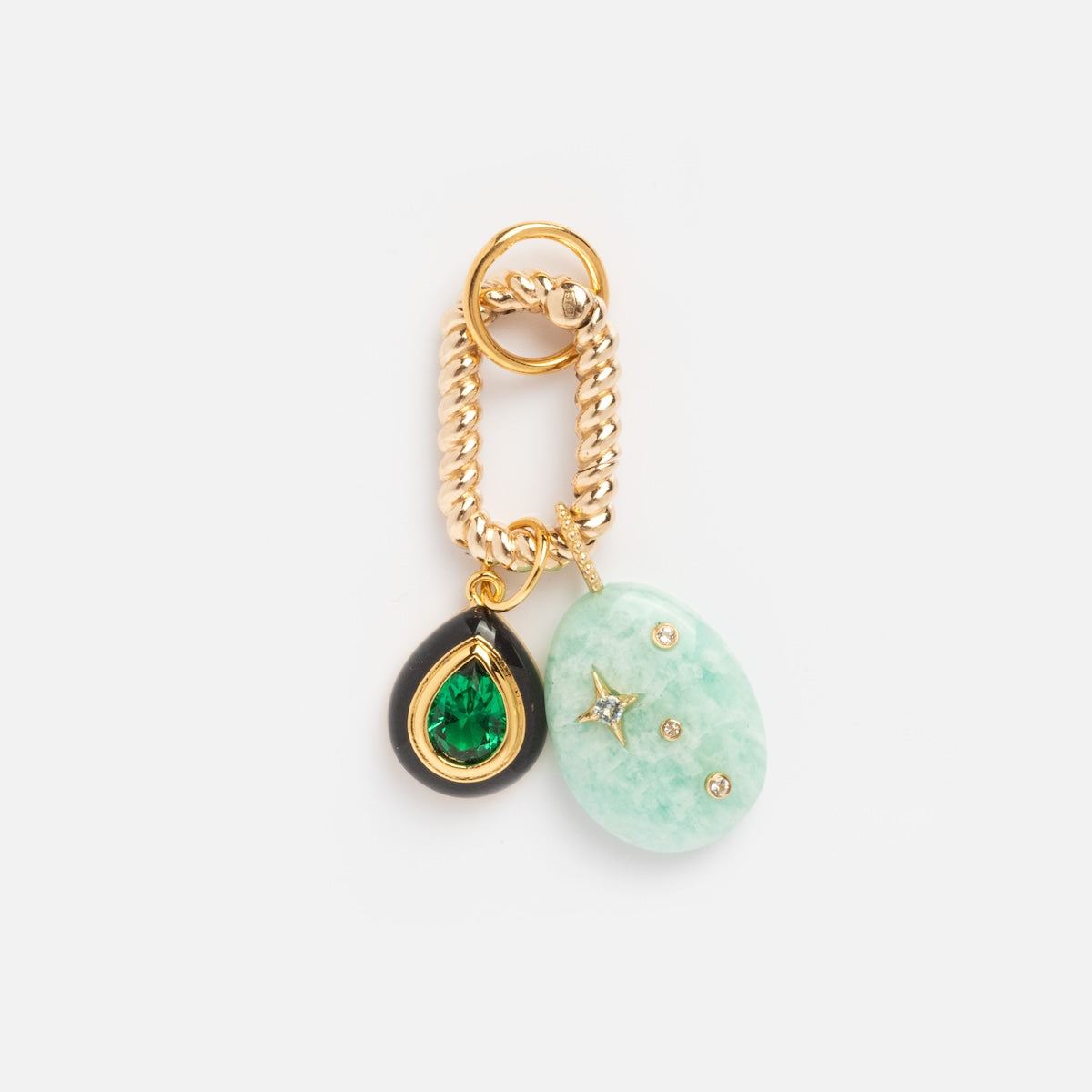 The Charm Clip is a gold chain keychain featuring a small black teardrop with a green gem and a larger light green oval stone accented with gold stars and dots, shown on a white background.