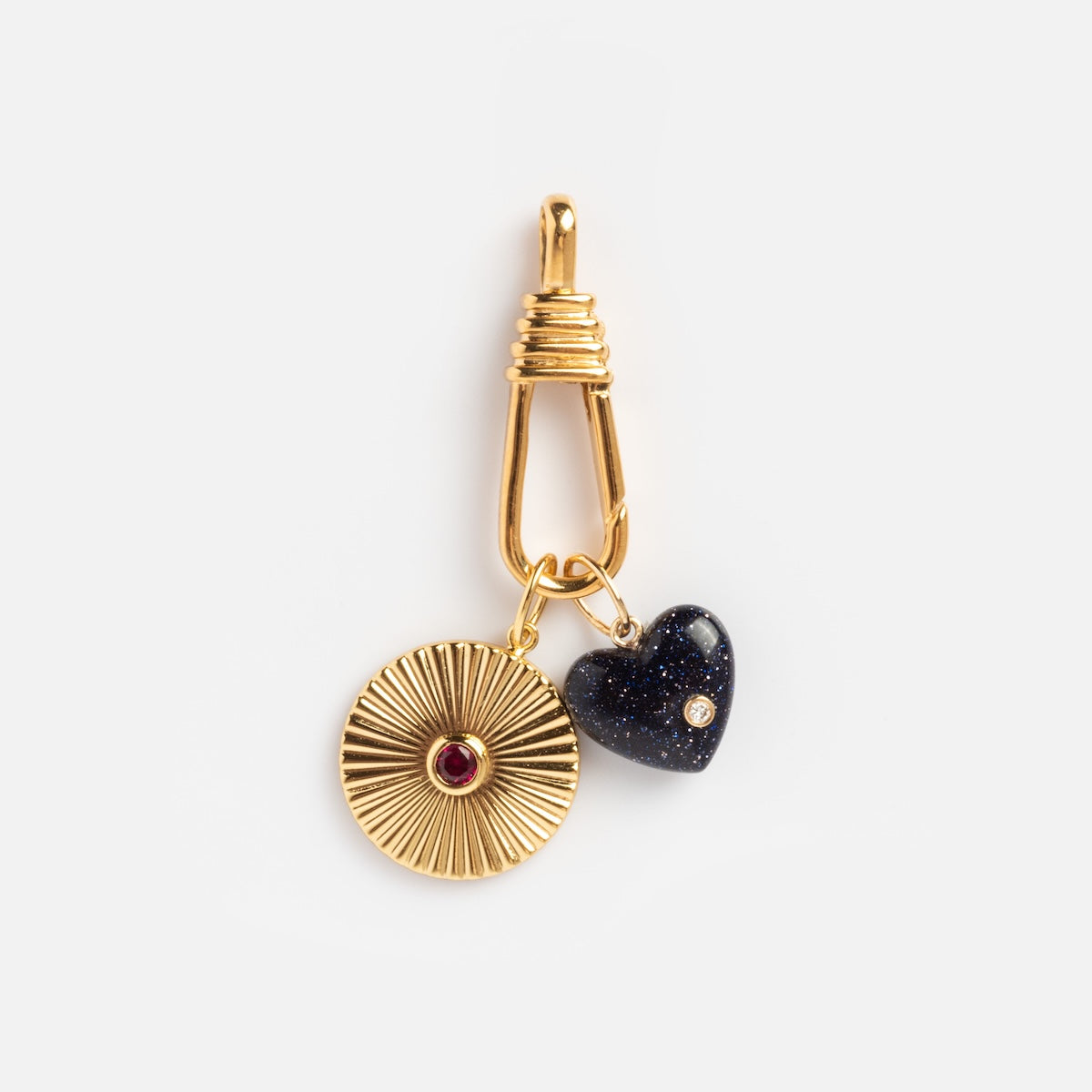 The Charm Clip features a textured gold vermeil circle charm with a red stone center and a small dark blue heart charm with a tiny gem—ideal as bracelet charms or to attach using the Charm Clip.
