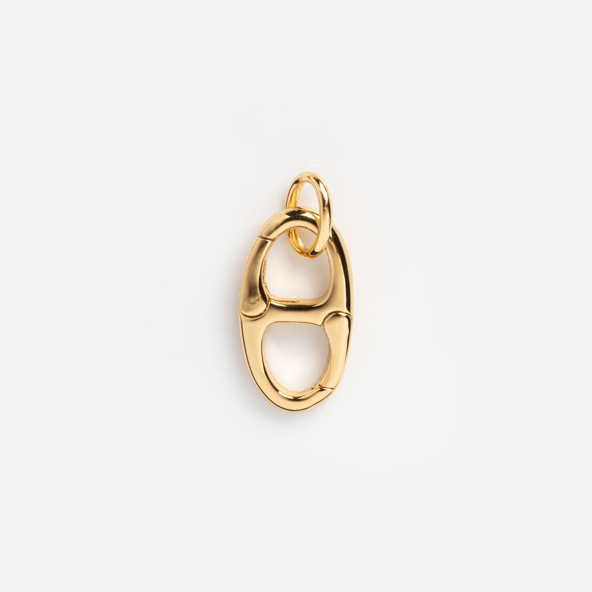 The Charm Clip is a shiny 14k gold vermeil pendant with interlocking oval and circular links, shown on a plain white background.