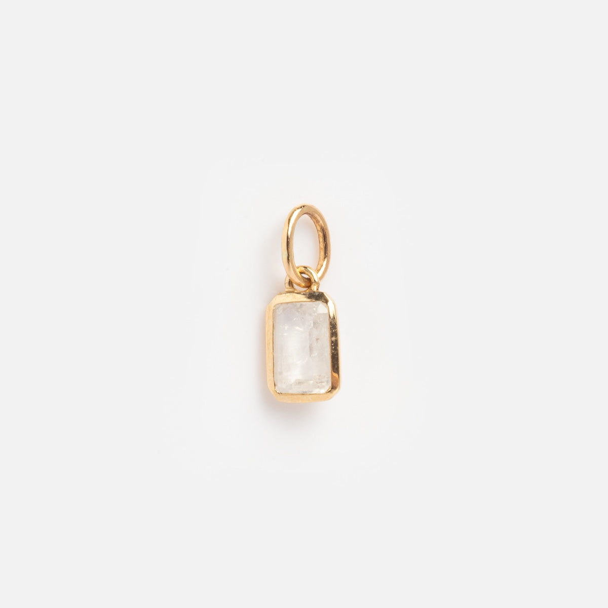 The Solid Gold Birthstone Baguette Charm June Sample is a small rectangular pendant with a clear, faceted stone set in gold and a gold loop, shown against a plain white background.