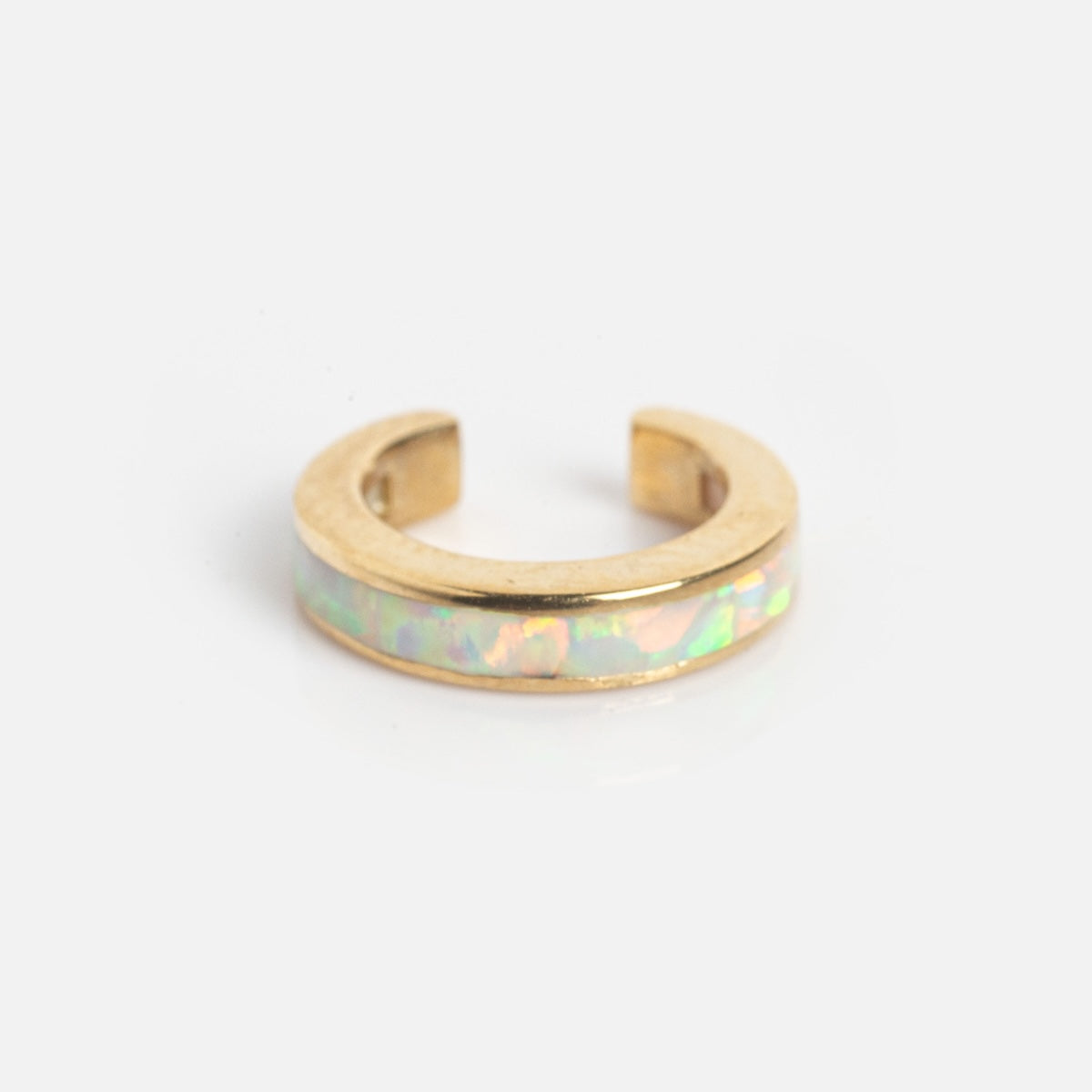 The Solid Gold Opal Inlay Ear Cuff Sample is a small gold ear cuff featuring an iridescent opal inlay, shown against a plain white background.