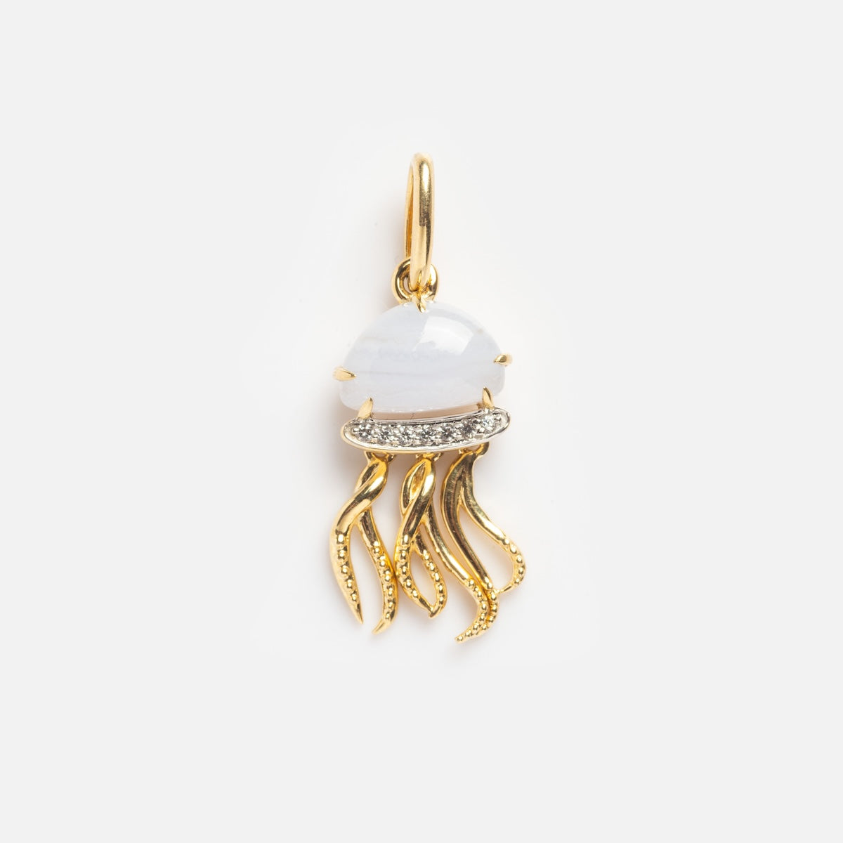 Blue Jellyfish Charm Sample featuring a blue jellyfish-shaped pendant with a white stone body, gold tentacle-like strands, and small clear gemstone accents, all hanging from a gold loop.