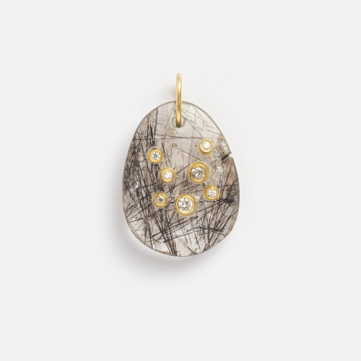The Black Rutile Aquarius Constellation Charm Sample showcases a polished translucent stone with black rutile inclusions, accented by small round gold bezels holding clear gems and finished with a gold loop for hanging.