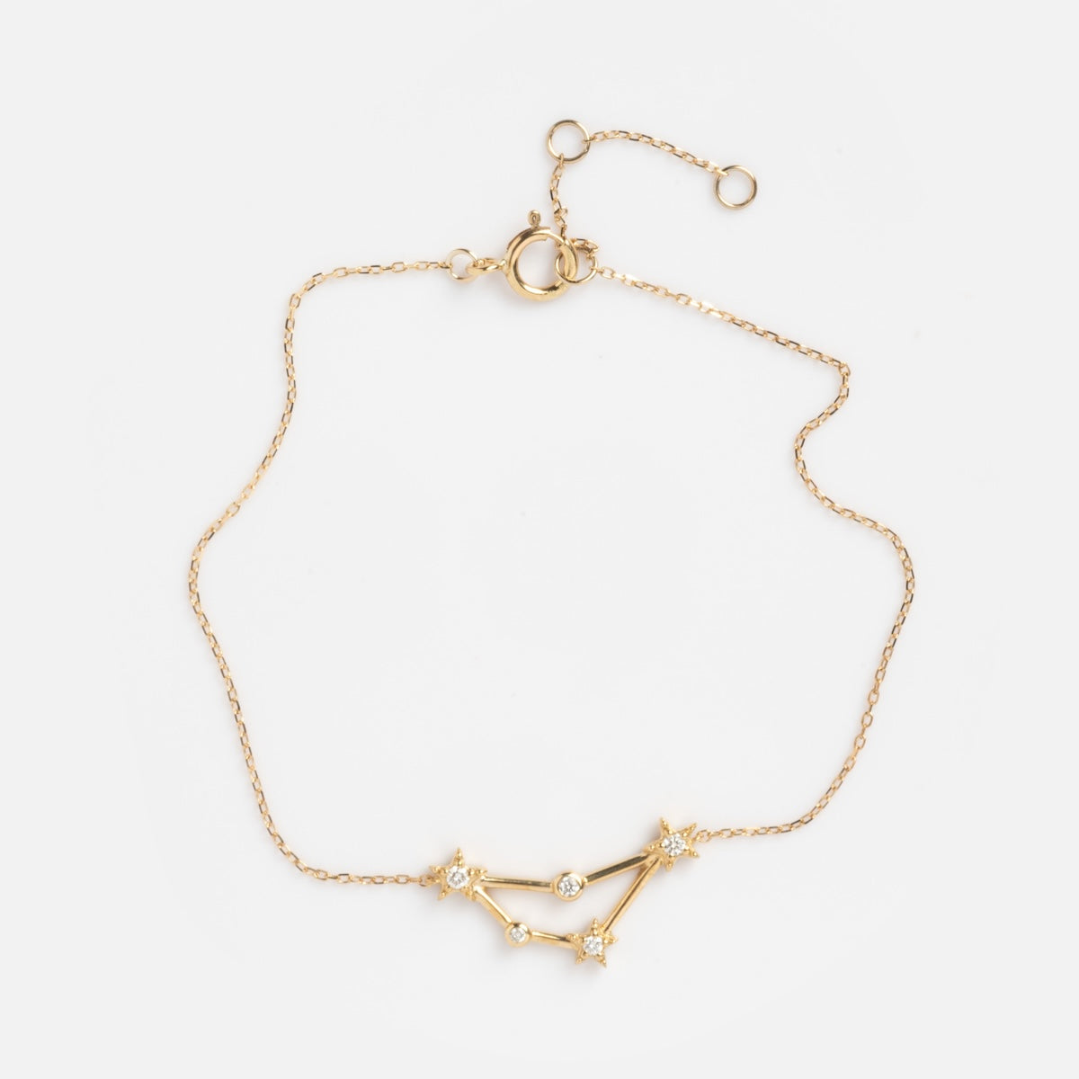 Solid Gold Zodiac Bracelet Capricorn Sample shown on a plain white background, featuring a delicate gold chain with a constellation design and small sparkling stones at each connecting point.