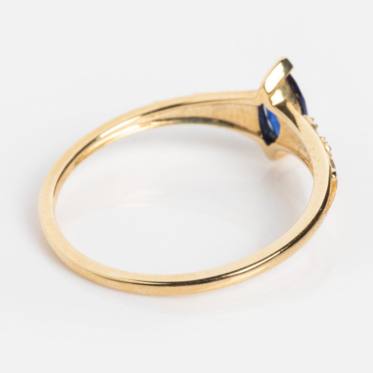 The Solid Gold 2025 September Capsule Classic Blue Sapphire Statement Ring features a delicate 9k yellow gold thin band with a lab-created blue sapphire in a raised prong setting, shown on a white background.