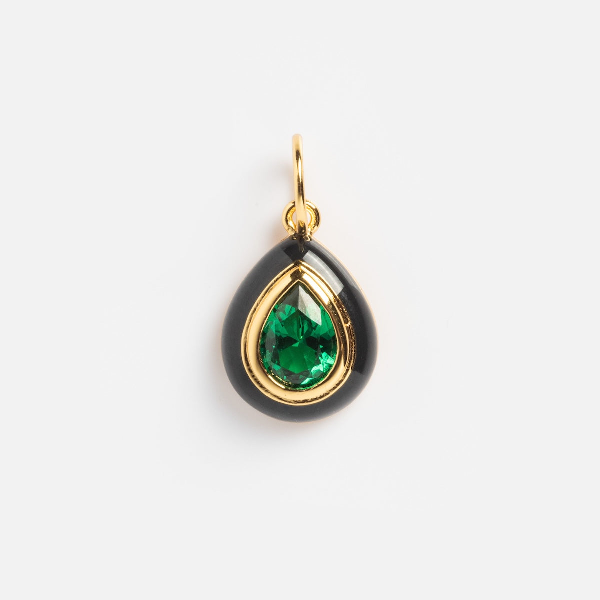 The Charms by Jurate JLA features a teardrop design with a yellow gold-plated frame, glossy black border, and a green faceted gemstone at the center, attached to a small gold loop—ideal for pairing with other charms or simulated diamond accents.