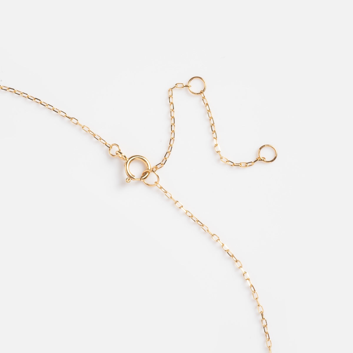 The Solid Gold 2025 September Capsule Classic Blue Sapphire Pendant Necklace features a delicate 9k yellow gold chain with a spring ring clasp and two unattached circular links, shown on a plain white background.