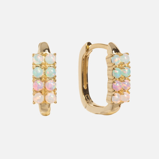 The Opal Ombre Rue Huggies are gold hoop earrings featuring two rows of small round opals in pastel pink, blue, and green shades, displayed on a plain white background.