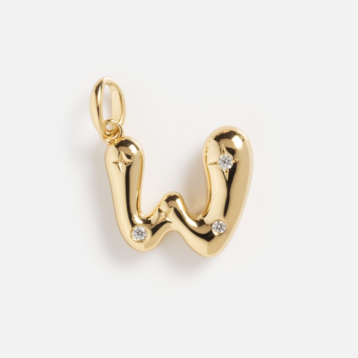 The Star Crossed Celestial Bubble Letter Charm is a shiny gold pendant shaped like a "W" with three embedded diamonds and a smooth, rounded design, displayed on a plain white background.
