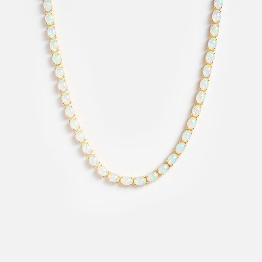 The Baby Blue Opal Eternal Tennis Necklace features oval opal gemstones evenly spaced along a gold chain, displayed on a plain white background.