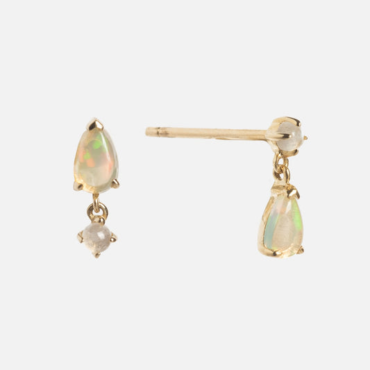 The Solid Gold 2025 October Capsule Opal Statement Set features gold stud earrings with dangling teardrop opals and small round gemstones above each teardrop, displayed on a plain white background. Free gift included.