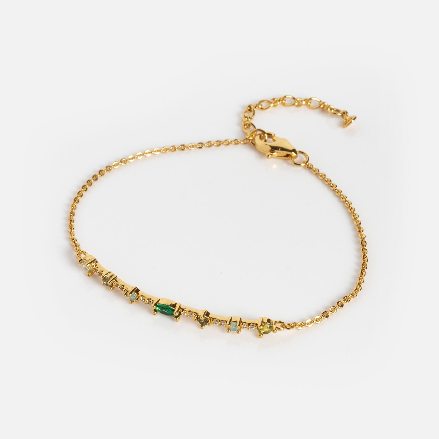 Colorful Bracelet Sample: A delicate gold chain bracelet with multi-shaped, multicolored gemstones set along the center and an adjustable clasp. Displayed on a plain white background.