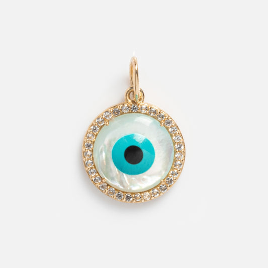 The Solid Gold Amulet Charm features an eye design with a blue and black center, surrounded by clear gemstones—an exclusive Local Eclectic piece thats perfect for enhancing your favorite gemstone necklace.