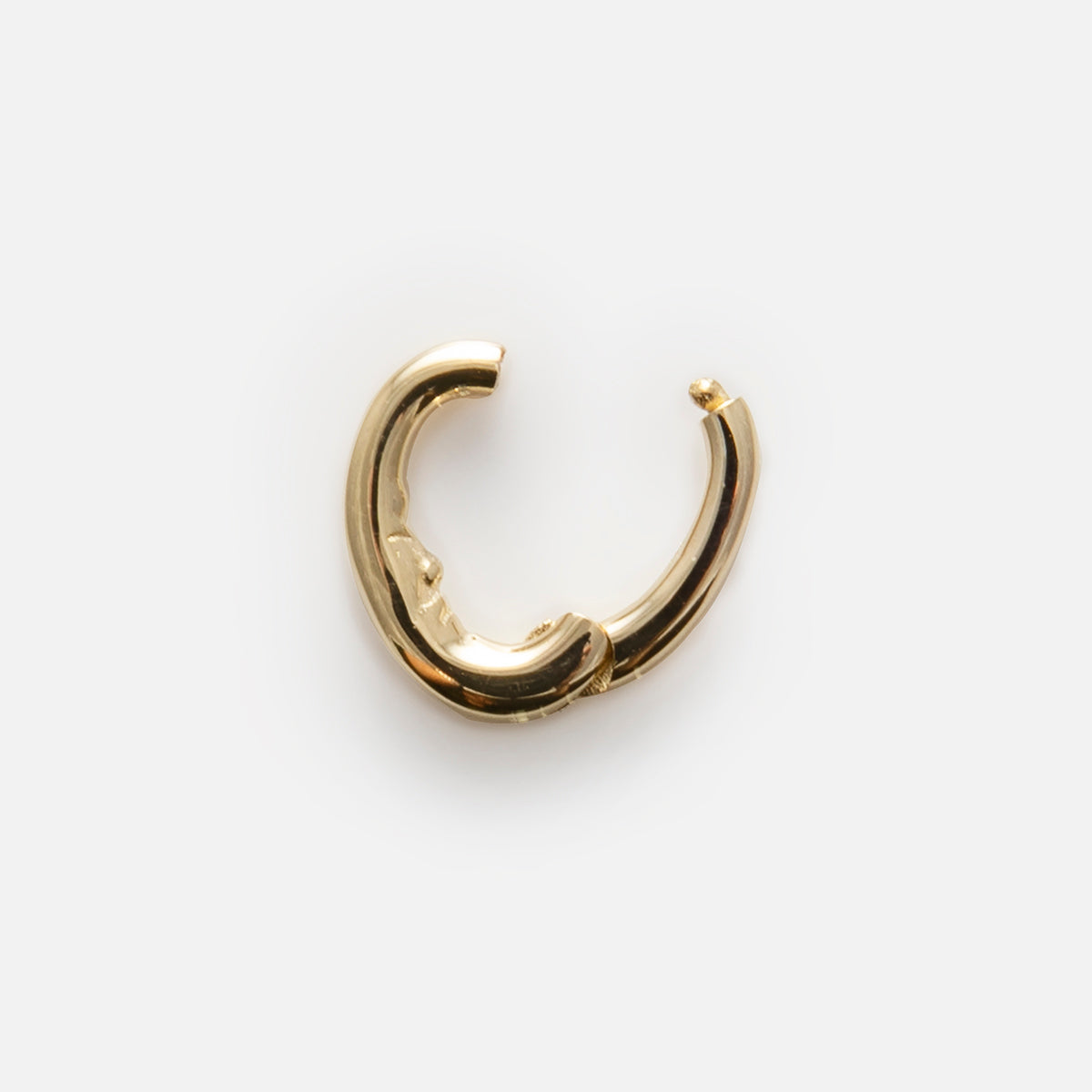 The Solid Gold Ring Clip is a single small gold hoop earring with a thick, rounded design and an open clasp, perfect for adding to your customizable ring stack, shown on a plain white background.