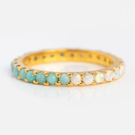 The Indecisive Opal and Amazonite Eternity Band is a yellow gold vermeil ring with alternating opal and amazonite stones in a continuous row, displayed against a clean white background.