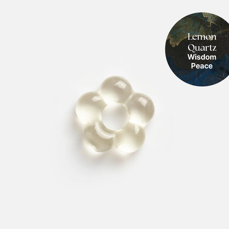 A translucent, flower-shaped lemon quartz crystal from Gemstone Spacer Charms by Mod and Jo is centered on a white background, perfect for customizable drop earrings. A circular label at the top right reads Lemon Quartz Wisdom Peace.