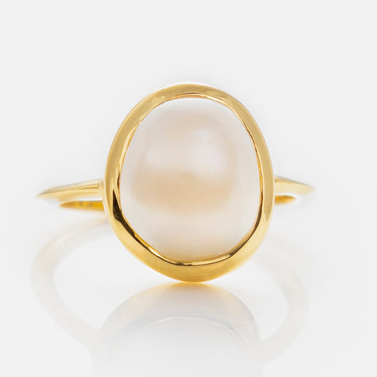 The Simple Semi Precious Pearl Ring showcases a large, round white pearl at its center, set in gold vermeil and displayed against a white background.