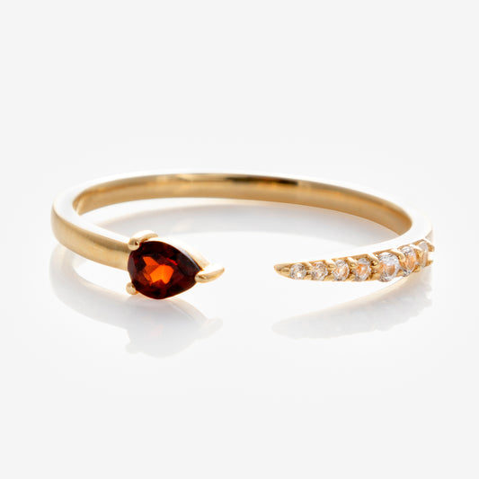 The Solid Gold Garnet and Sapphire Open Front Band in 9k yellow gold features a pear-shaped garnet on one end and a row of white sapphires on the other, shown against a white background.
