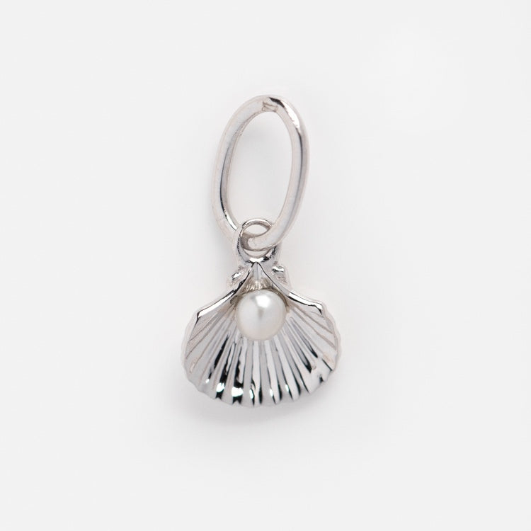 A Solid Gold Nature Charm in white gold, designed as a scallop shell with a central pearl detail and attached to an oval loop, shown against a plain white background.
