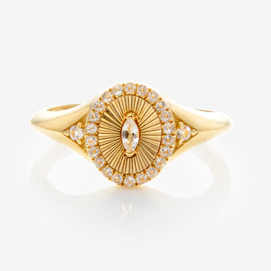 The Solid Gold White Topaz Etched Signet Pinky Ring features a sunburst-etched oval center, highlighted by a marquise-cut white topaz, with a halo of small round stones and diamond accents on the band.